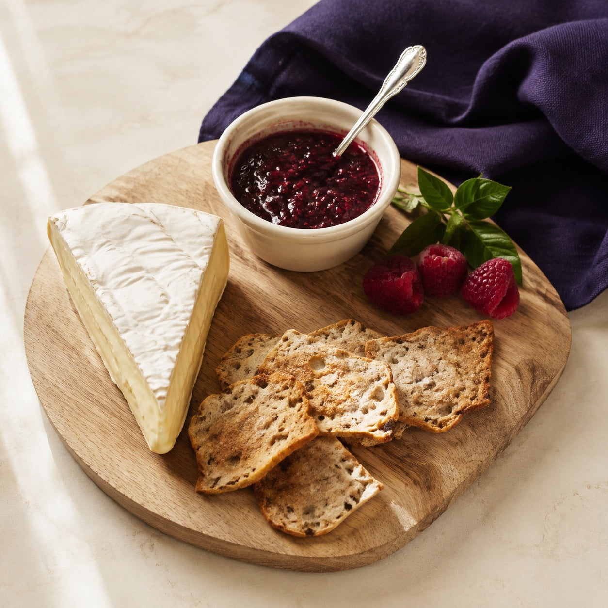 Brie and crackers with berry pepper jam