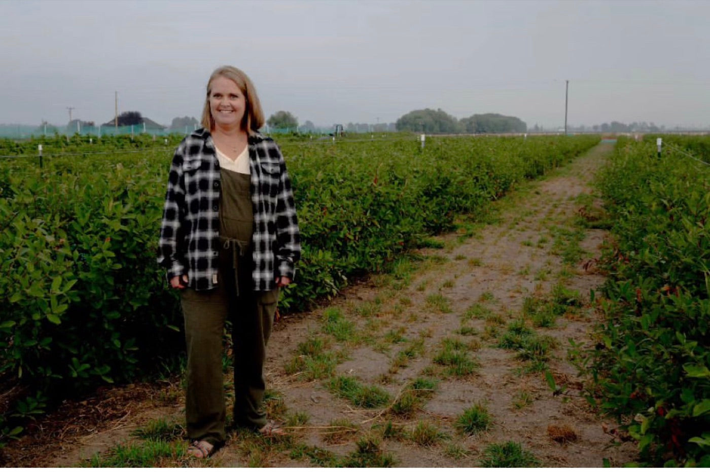 Melissa Allred standing in the berry rows at Aspen Grove Farm